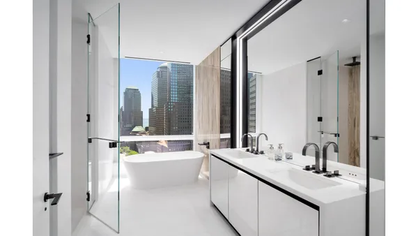 a bedroom with furniture and a large window