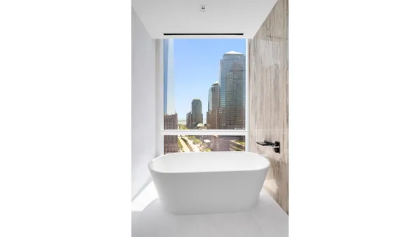 a bathroom with a double vanity sink and a bathtub