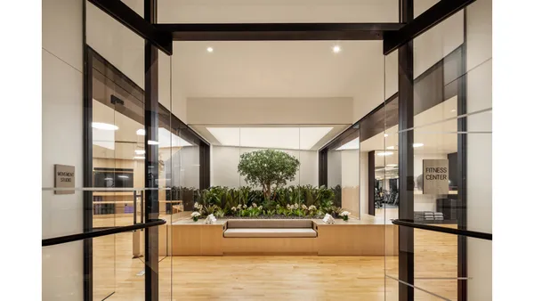 a view of a hall with wooden floor and entryway