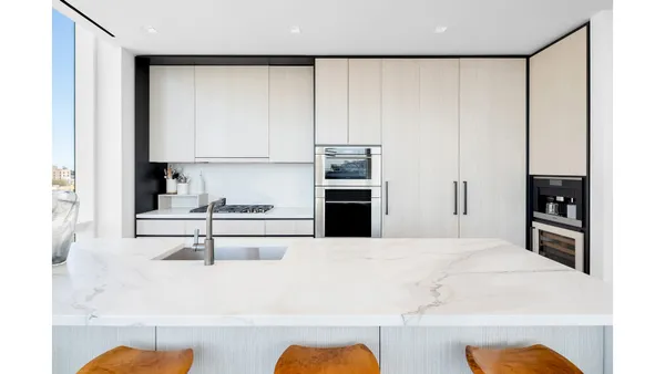 a kitchen with stainless steel appliances kitchen island granite countertop a table chairs in it and a window