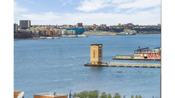 a dining room with furniture and a floor to ceiling window