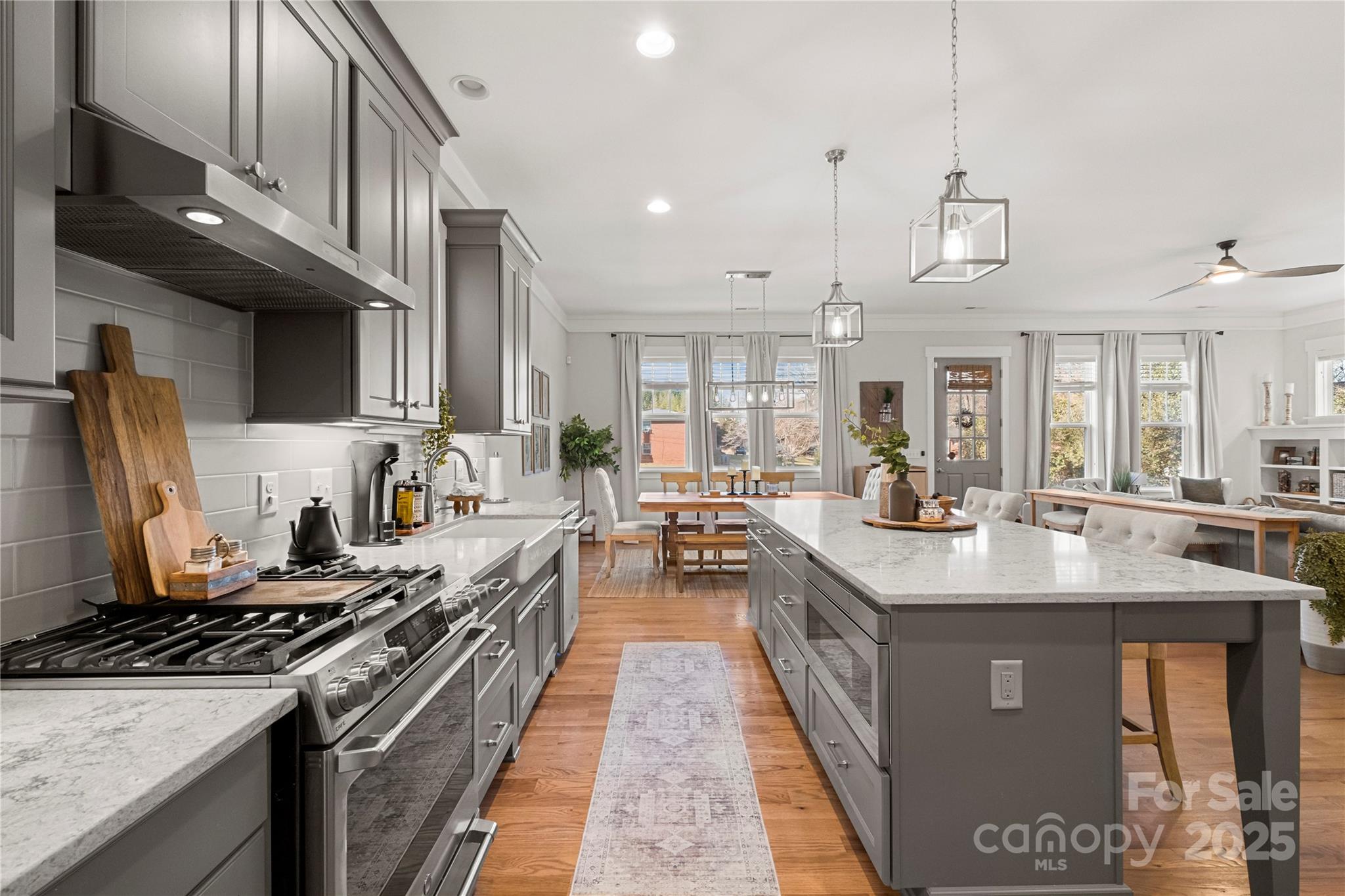 907 Millbrook Road Charlotte, NC 28211 - Photo 11 of 46 a large kitchen with stainless steel appliances granite countertop a large stove a sink dishwasher and cabinets with wooden floor