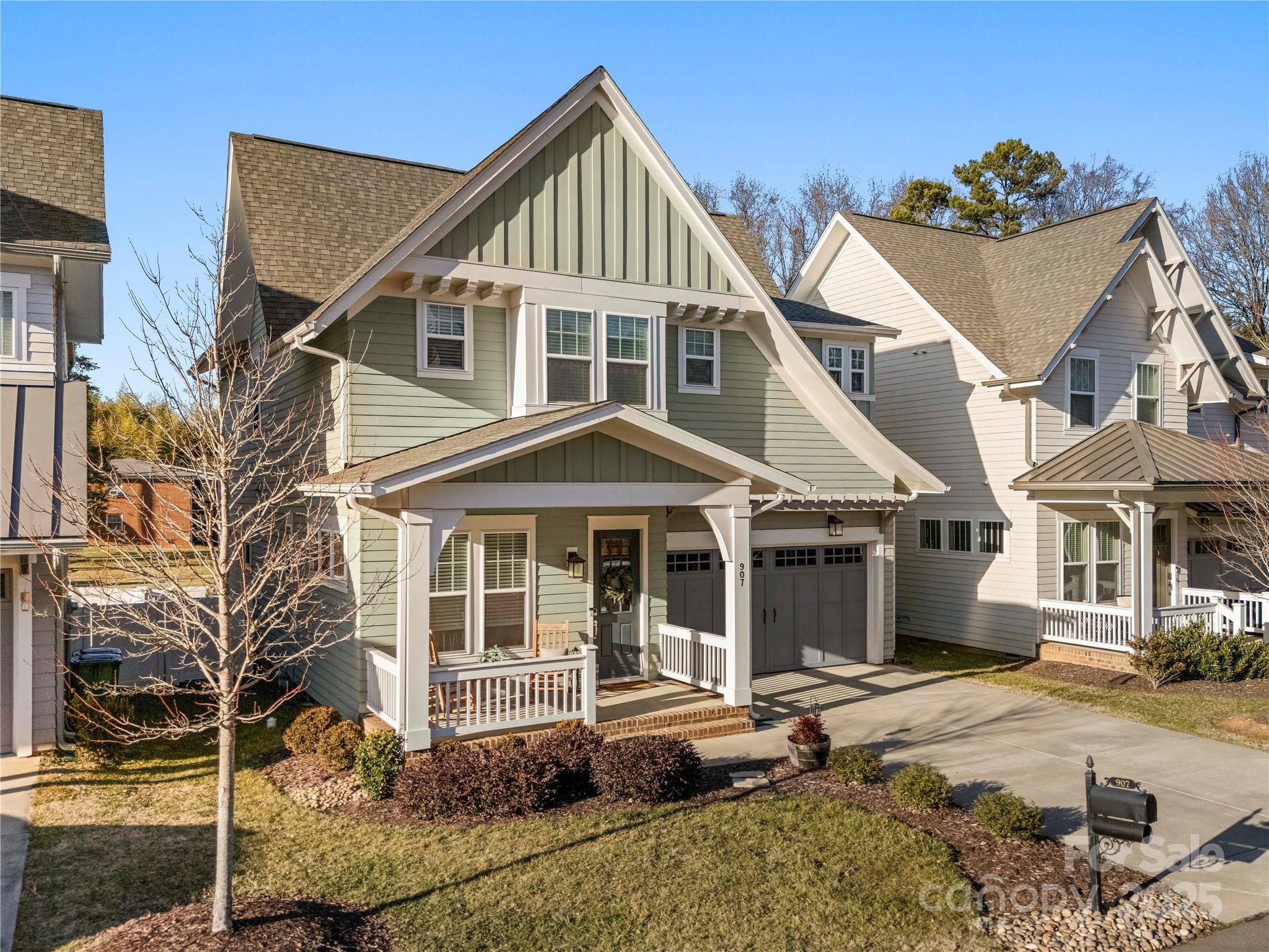 907 Millbrook Road Charlotte, NC 28211 - Photo 2 of 46 a view of a white house with a small yard and large windows