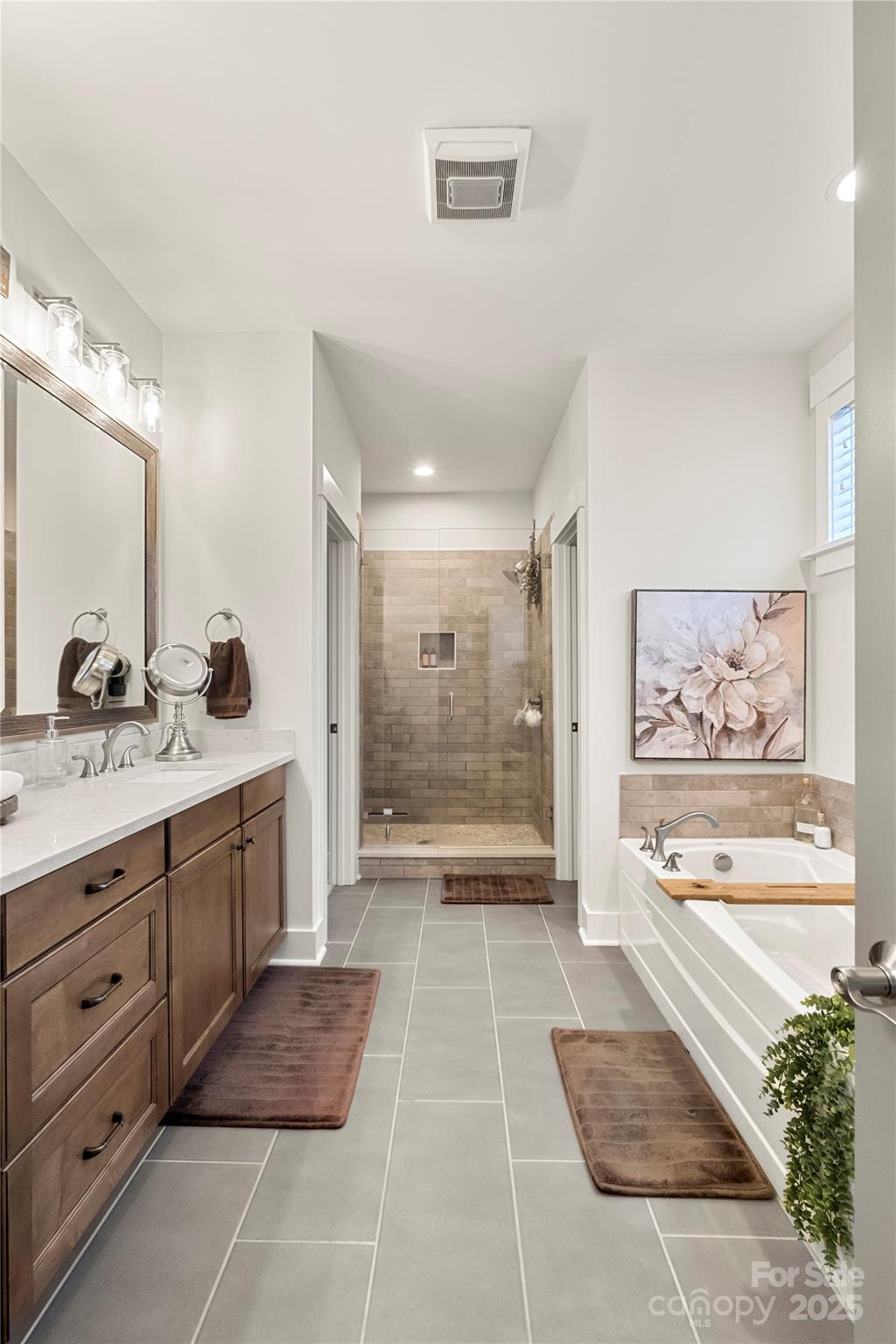 907 Millbrook Road Charlotte, NC 28211 - Photo 30 of 46 a bathroom with a sink a large mirror and a shower