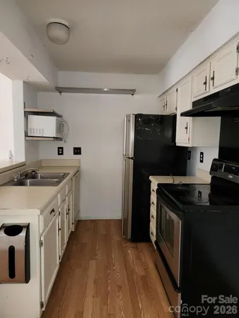 a kitchen with stainless steel appliances granite countertop a stove and a refrigerator