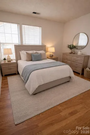 a bedroom with a bed and a large window