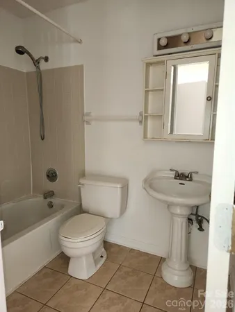 a bathroom with a sink a toilet and bathtub