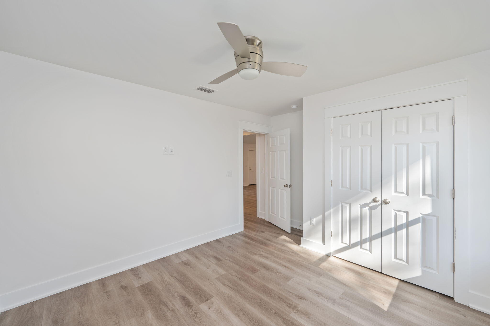 68 Iris Lane DeFuniak Springs, FL 32433 - Photo 14 of 34 an empty room with wooden floor and windows