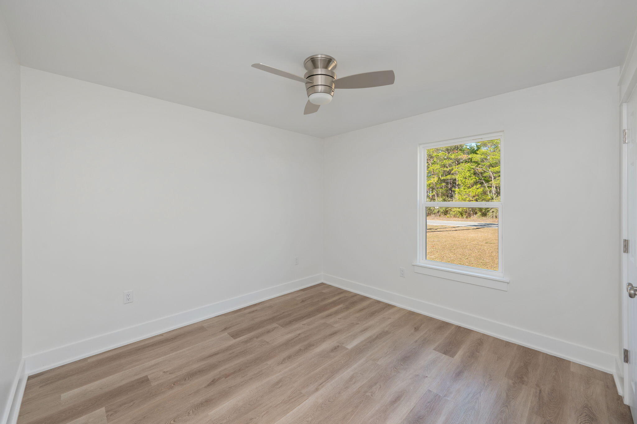 68 Iris Lane DeFuniak Springs, FL 32433 - Photo 15 of 34 an empty room with a window and a ceiling fan