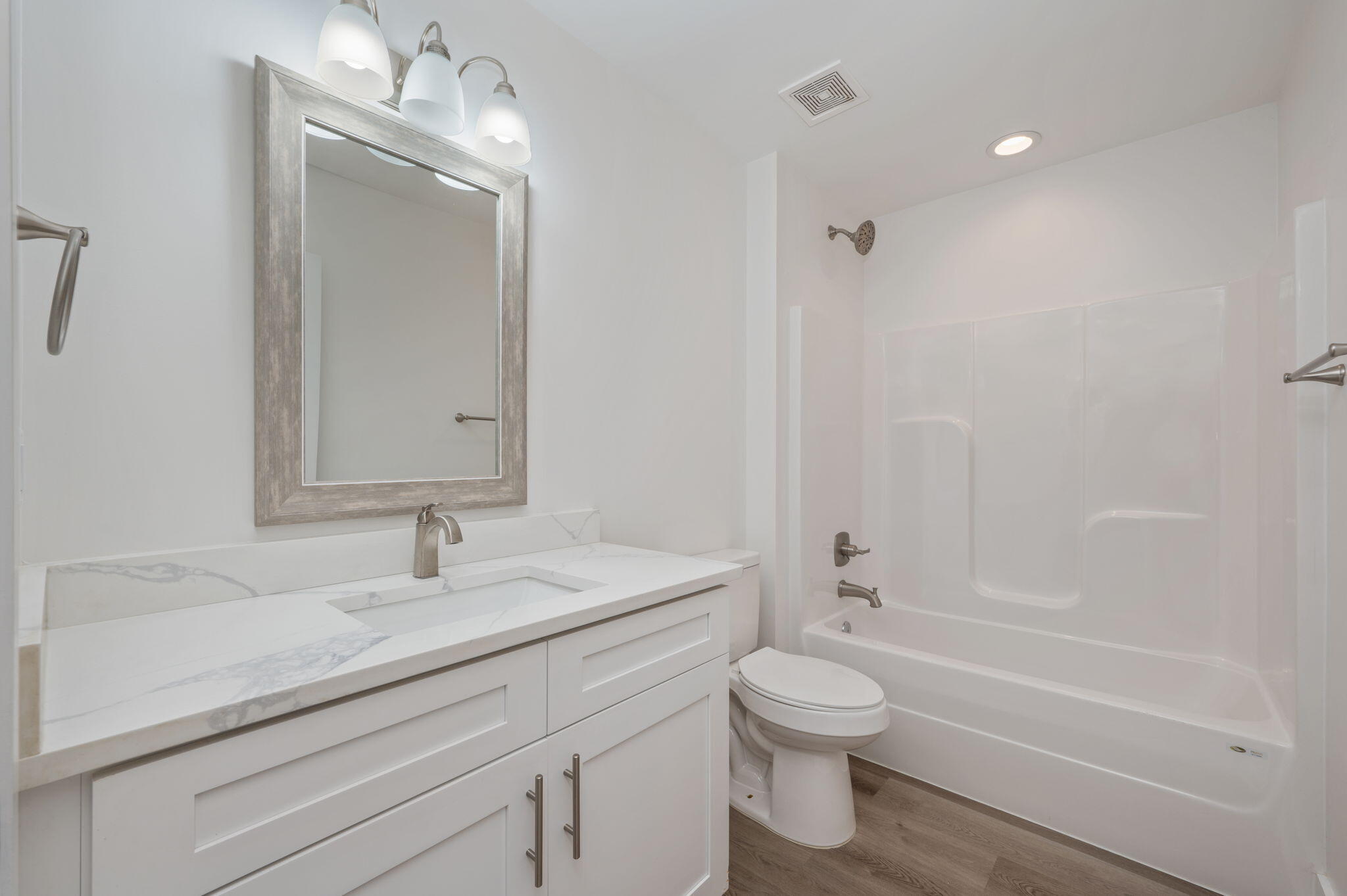68 Iris Lane DeFuniak Springs, FL 32433 - Photo 17 of 34 a bathroom with a granite countertop sink a toilet and a bathtub
