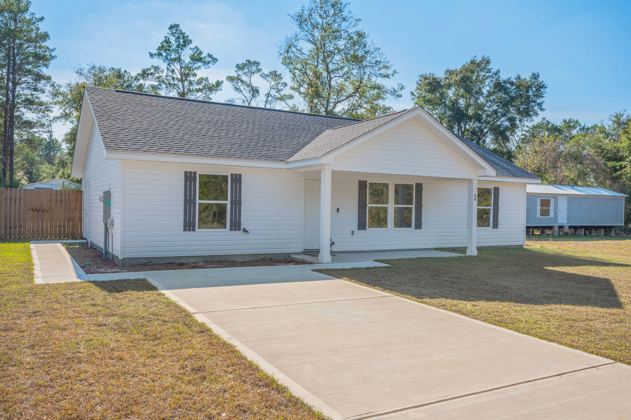 68 Iris Lane DeFuniak Springs, FL 32433 - Photo 2 of 34 a front view of a house with a yard and garage