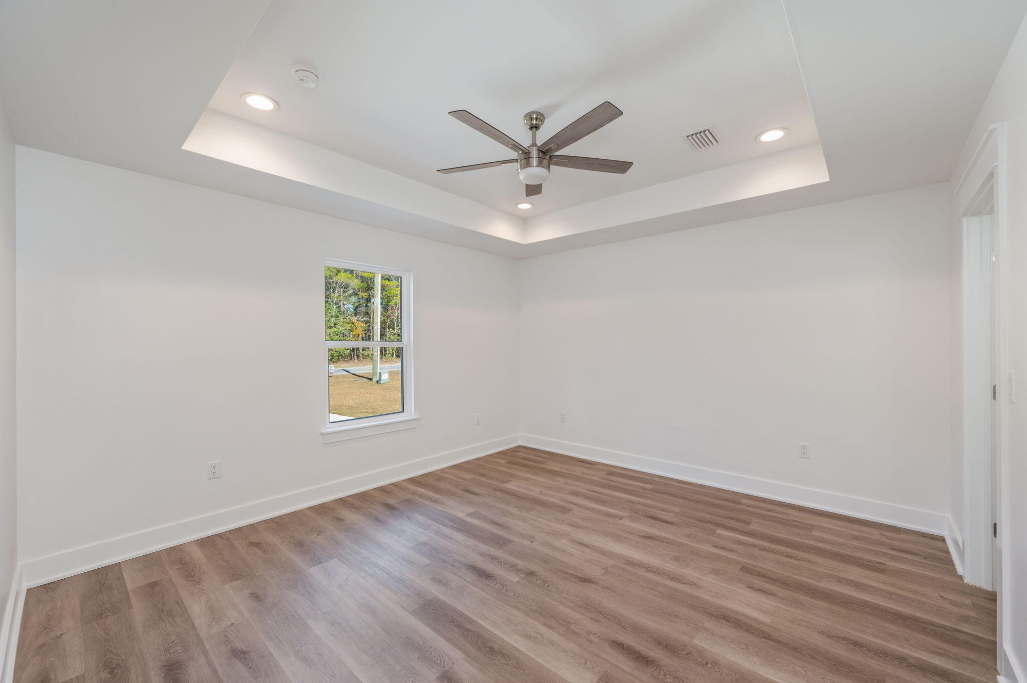 68 Iris Lane DeFuniak Springs, FL 32433 - Photo 24 of 34 an empty room with a window and a ceiling fan
