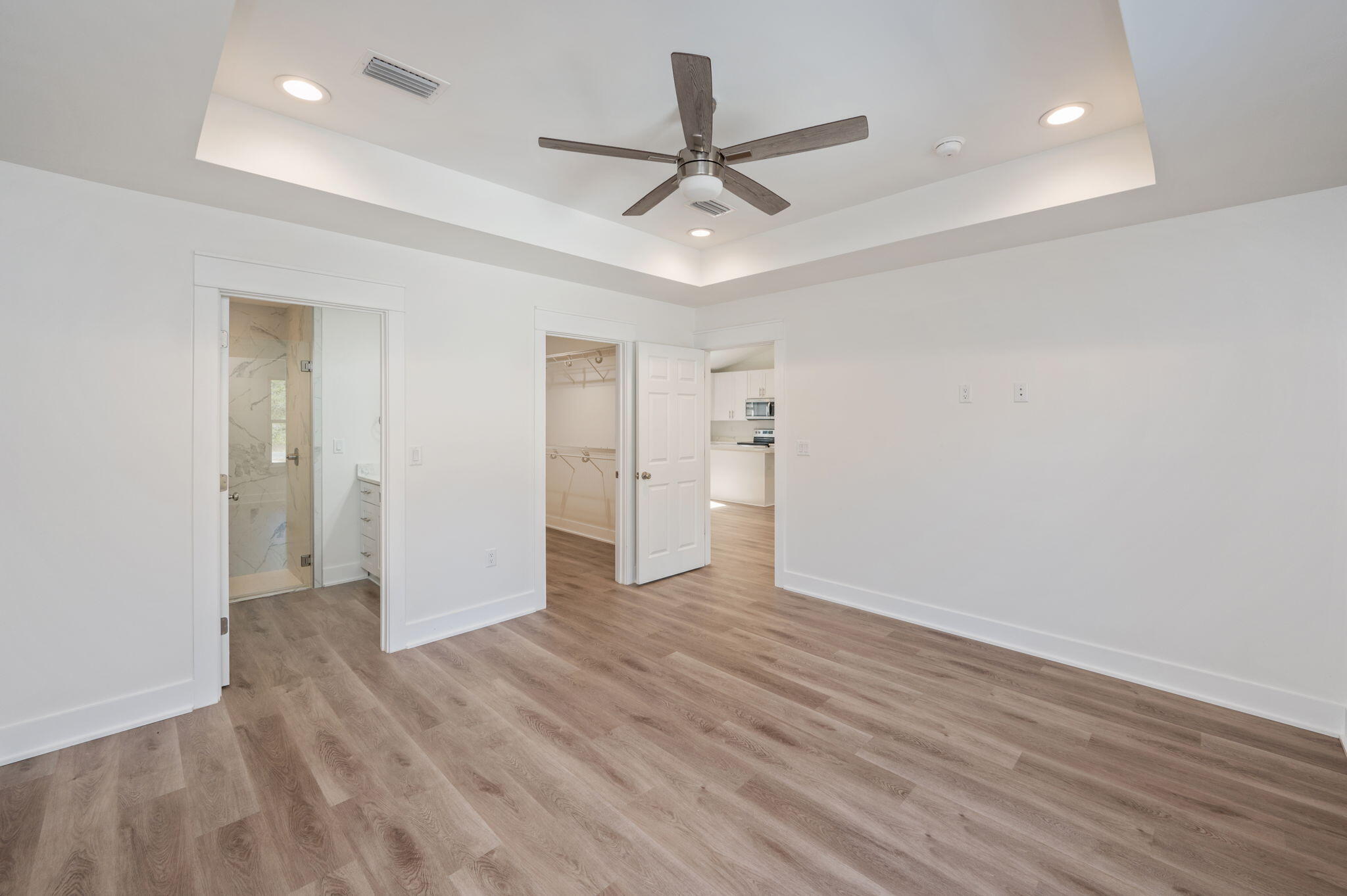 68 Iris Lane DeFuniak Springs, FL 32433 - Photo 26 of 34 wooden floor in an empty room with a ceiling fan