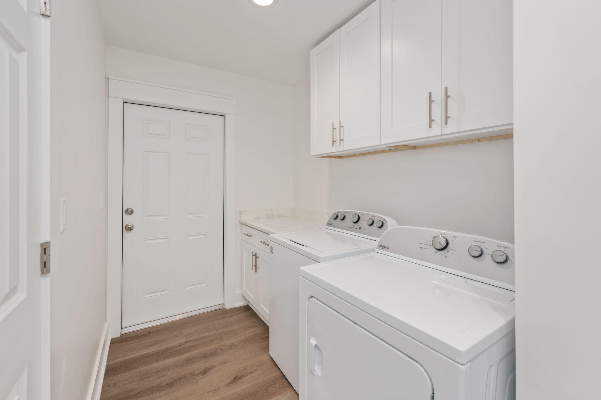 68 Iris Lane DeFuniak Springs, FL 32433 - Photo 28 of 34 a view of washer and dryer with kitchen in the background
