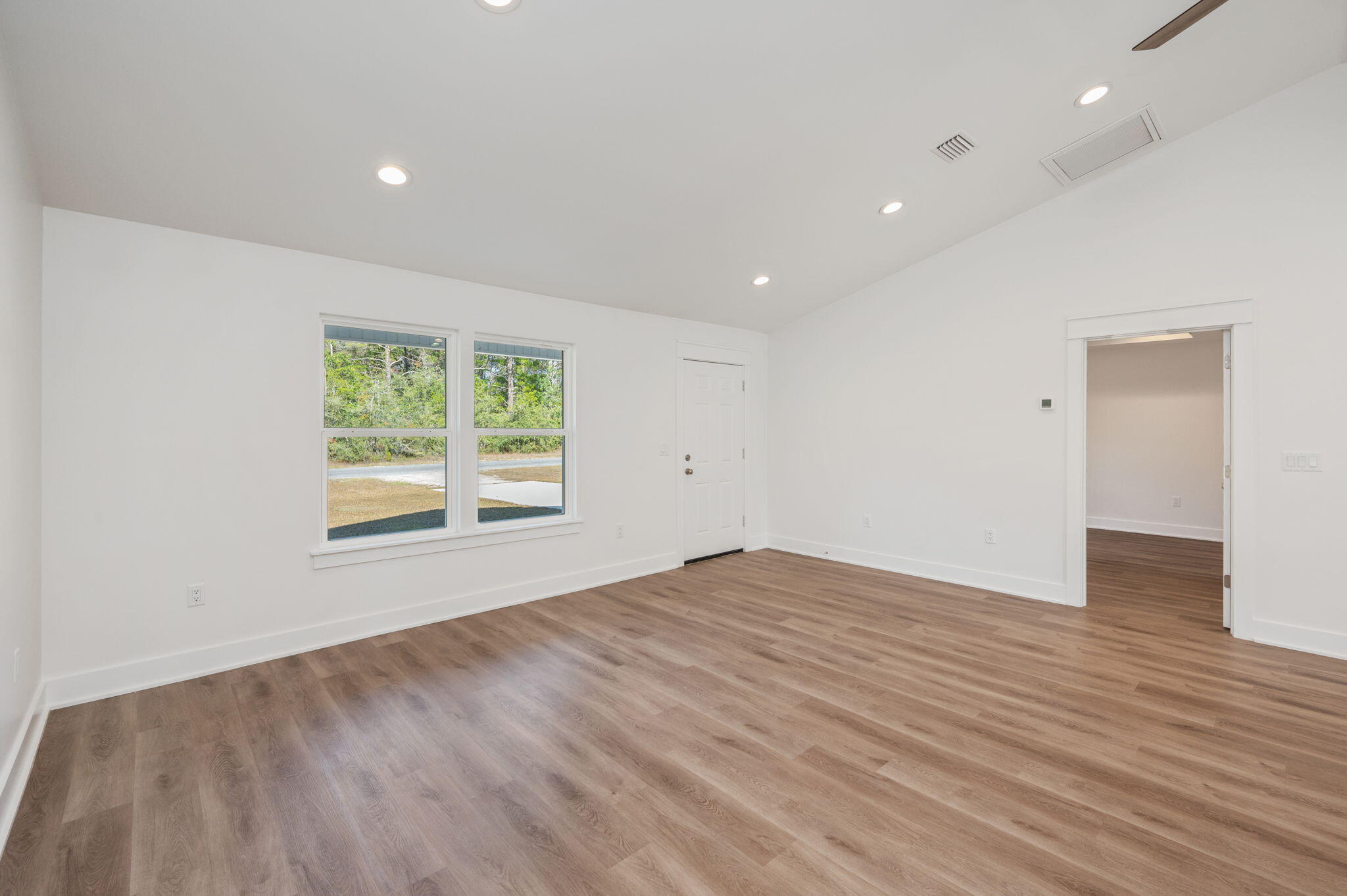 68 Iris Lane DeFuniak Springs, FL 32433 - Photo 7 of 34 an empty room with wooden floor and windows