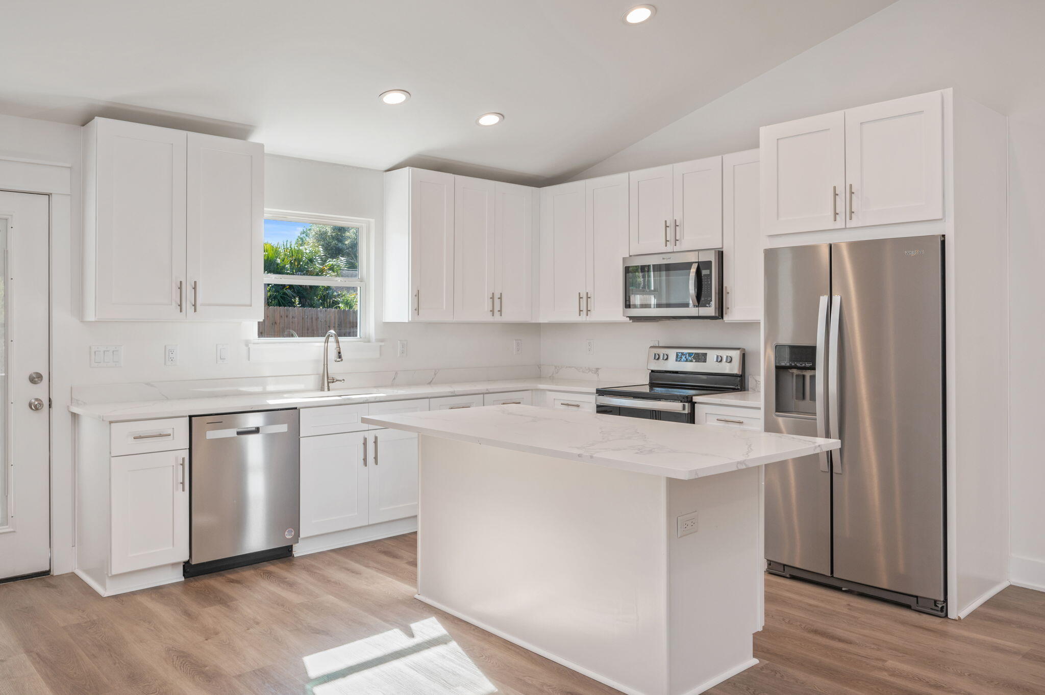 68 Iris Lane DeFuniak Springs, FL 32433 - Photo 9 of 34 a kitchen with kitchen island a white cabinets and refrigerator