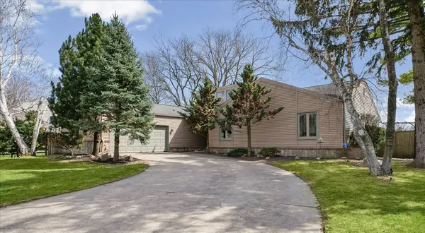 a backyard of a house with lots of green space and fountain
