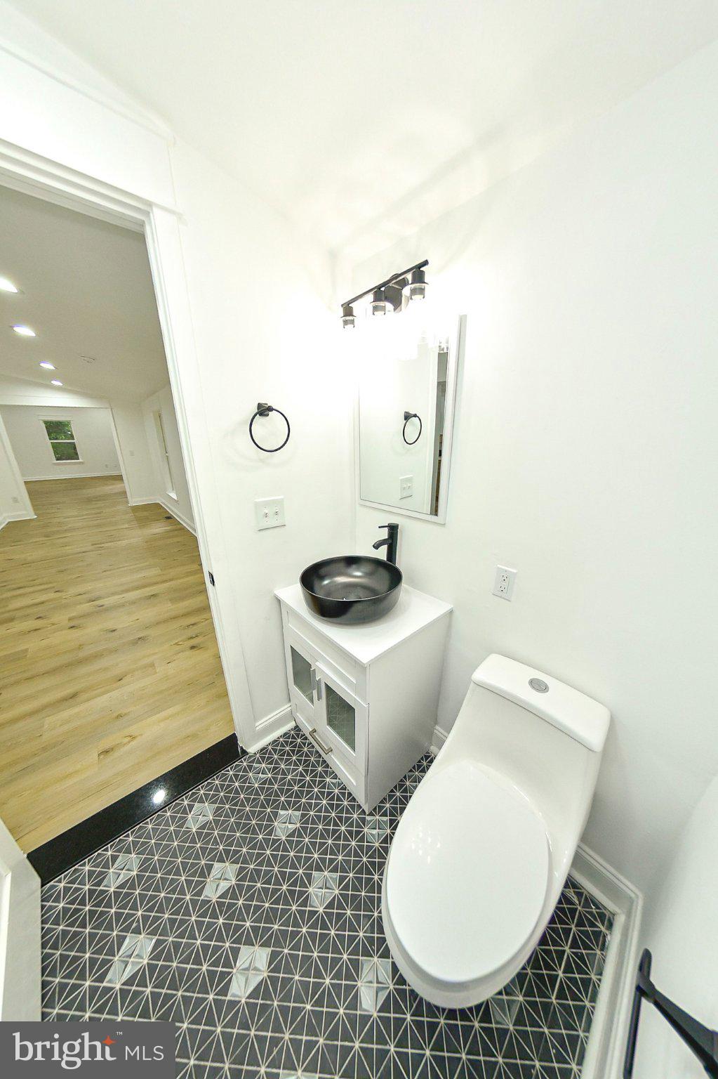3704 Suitland Road Southeast Washington, DC 20020 - Photo 56 of 70 a bathroom with a toilet and a sink