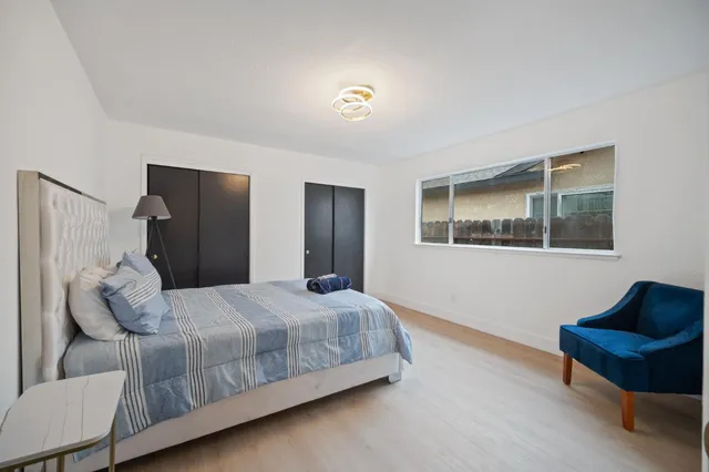 a bedroom with a bed and a couch