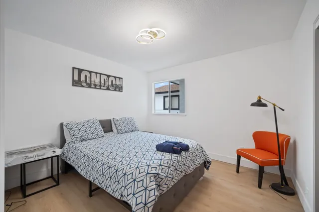 a bedroom with a bed and chair