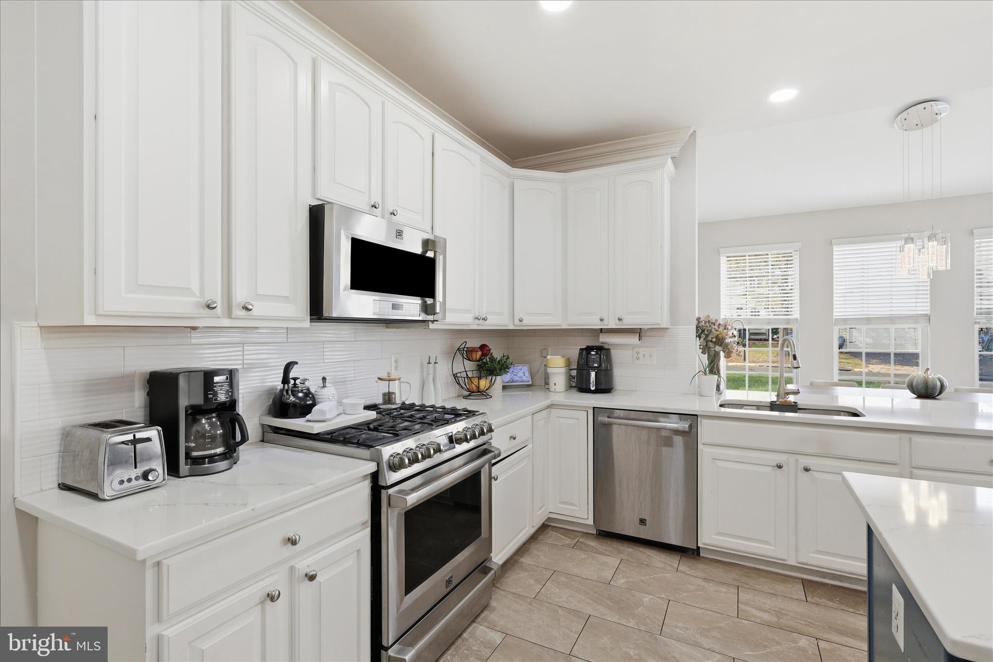 6711 Selbourne Lane Gainesville, VA 20155 - Photo 15 of 55 a kitchen with a sink stove top oven and cabinets
