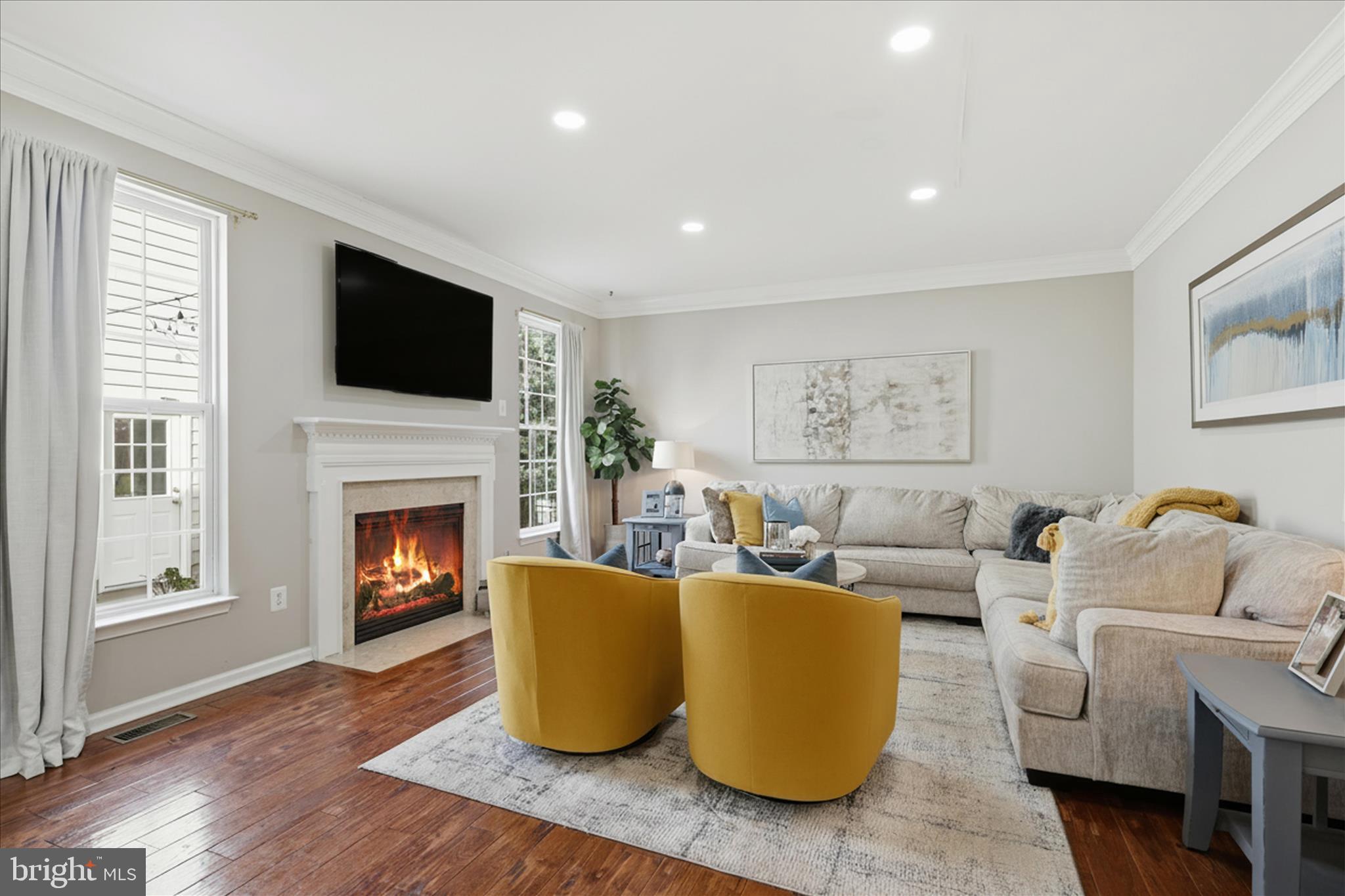 6711 Selbourne Lane Gainesville, VA 20155 - Photo 22 of 55 a living room with fireplace furniture and a flat screen tv