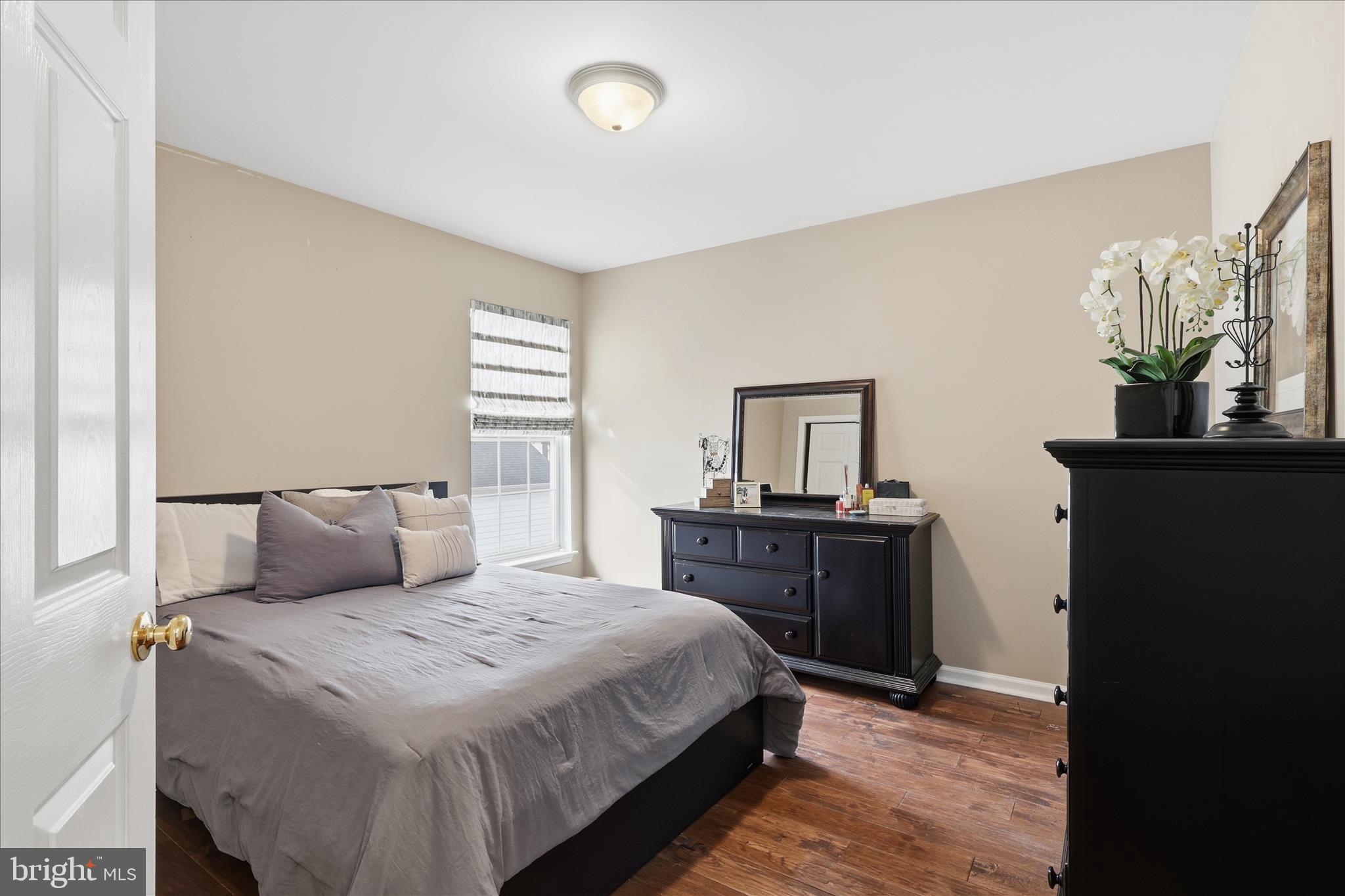 6711 Selbourne Lane Gainesville, VA 20155 - Photo 34 of 55 a bedroom with a bed and wooden floor