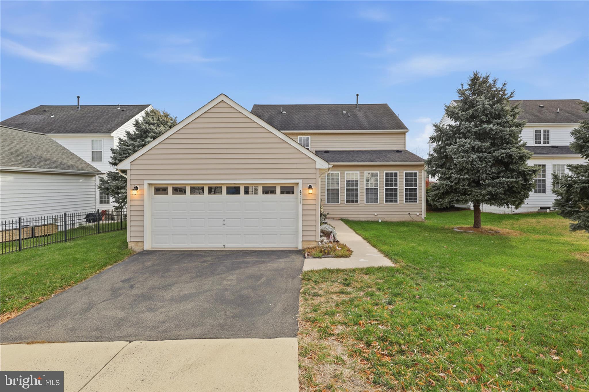6711 Selbourne Lane Gainesville, VA 20155 - Photo 46 of 55 a front view of a house with a yard and garage