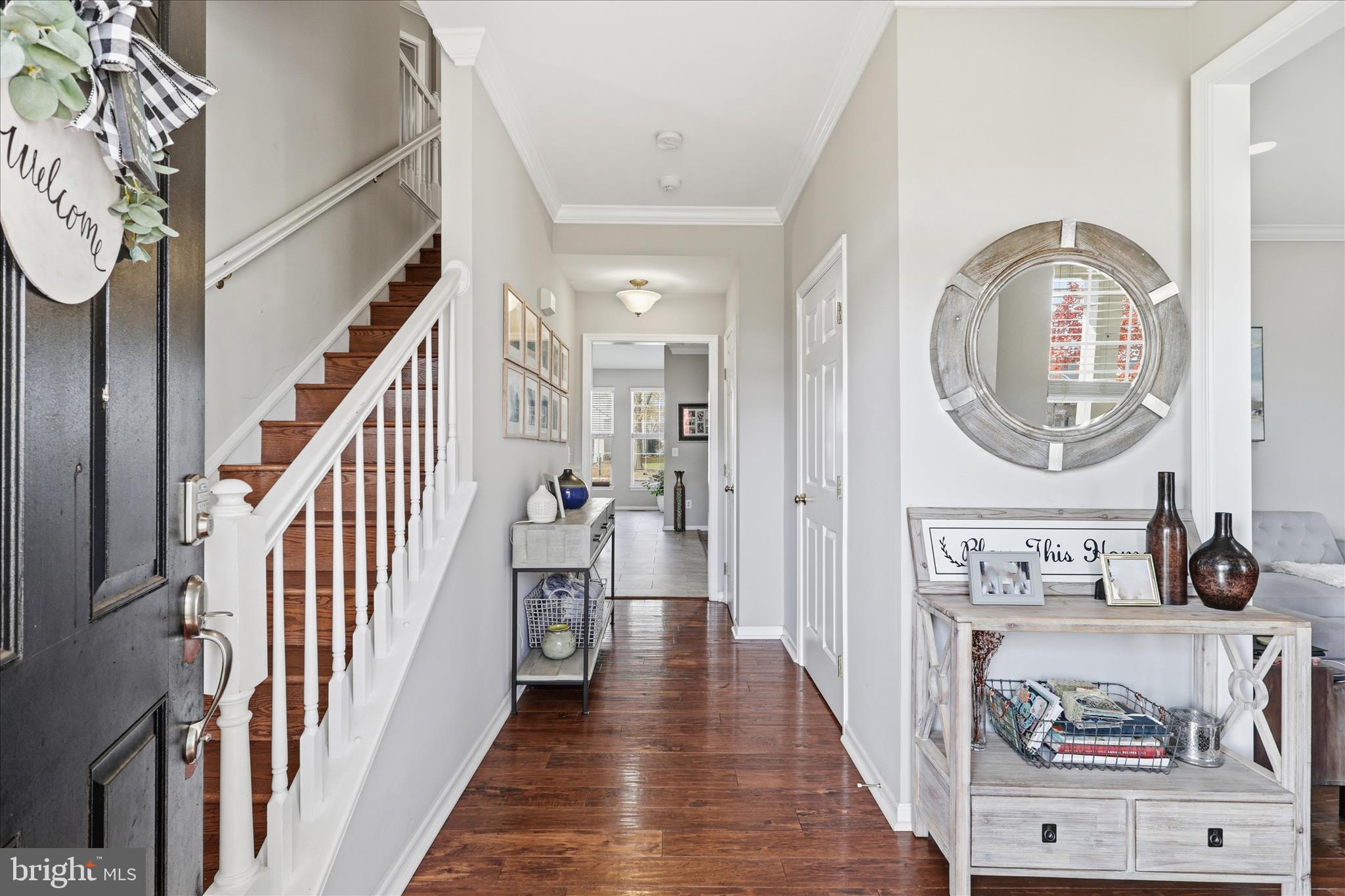 6711 Selbourne Lane Gainesville, VA 20155 - Photo 6 of 55 a view of a hallway with wooden floor and entryway