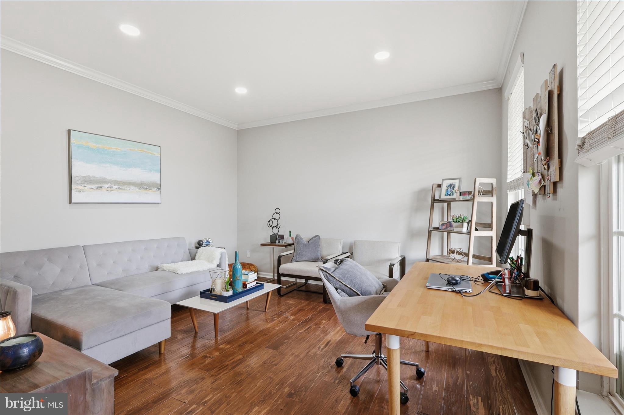 6711 Selbourne Lane Gainesville, VA 20155 - Photo 7 of 55 a living room with furniture a flat screen tv and a table