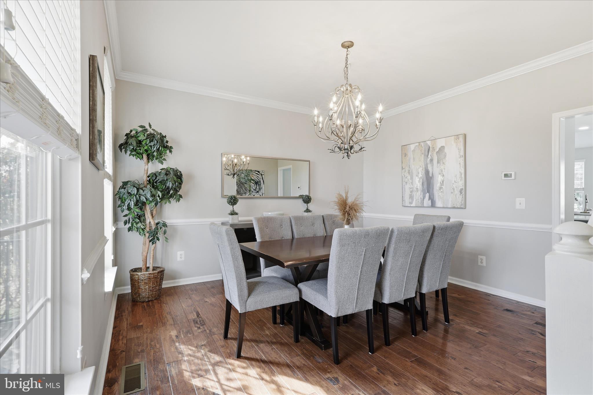 6711 Selbourne Lane Gainesville, VA 20155 - Photo 9 of 55 a view of a dining room with furniture window and wooden floor