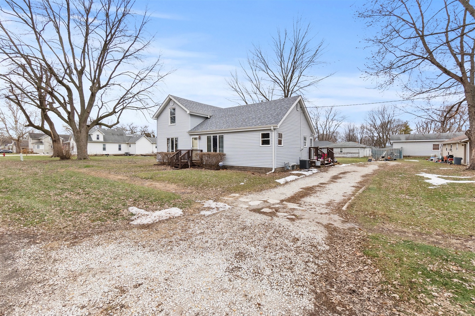 303 South Jackson Street Gardner, IL 60424 - Photo 2 of 29 a view of a yard with a large tree