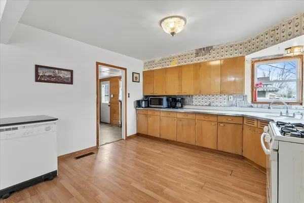 a kitchen with stainless steel appliances a stove top oven and a refrigerator