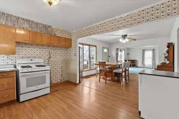 a view of a kitchen with dining table and chairs