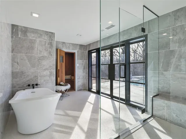 a bathroom with a bathtub and a shower