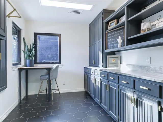 a view of kitchen with granite countertop window and front door