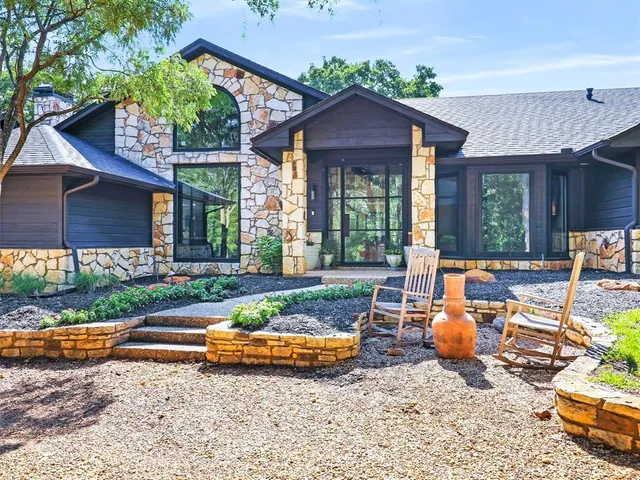 a view of a house with backyard and sitting area