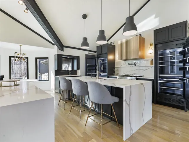 a kitchen with stainless steel appliances granite countertop a stove and a refrigerator