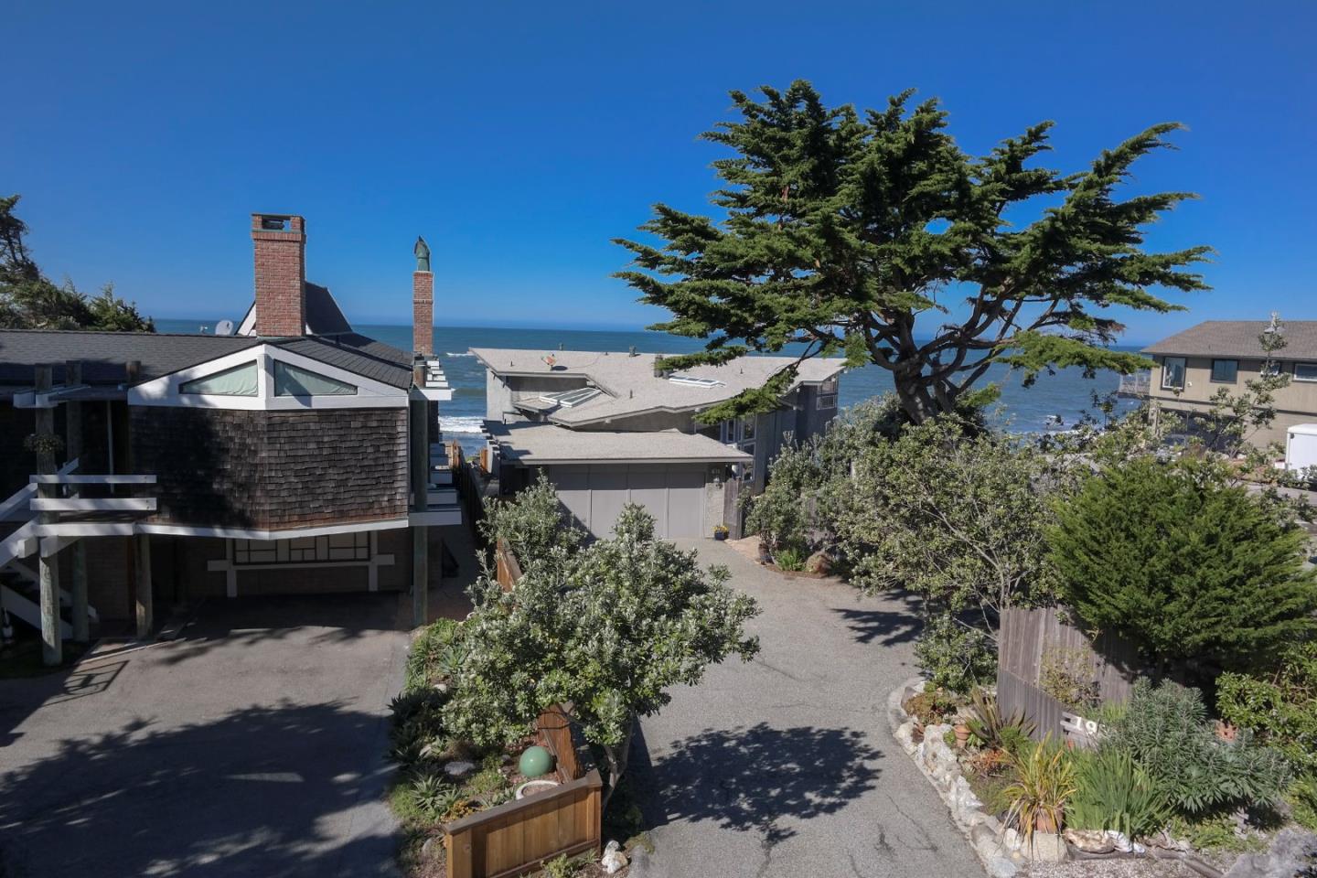 193 Reef Point Road Moss Beach, CA 94038 - Photo 2 of 27 a front view of a house with a yard