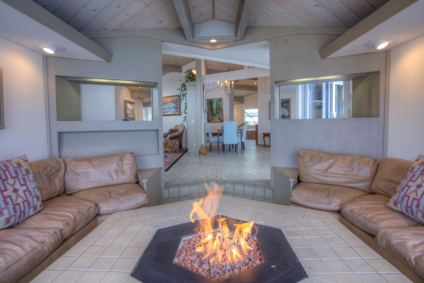 193 Reef Point Road Moss Beach, CA 94038 - Photo 7 of 27 a living room with furniture and a fireplace