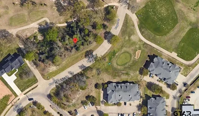 an aerial view of a residential apartment building with a yard