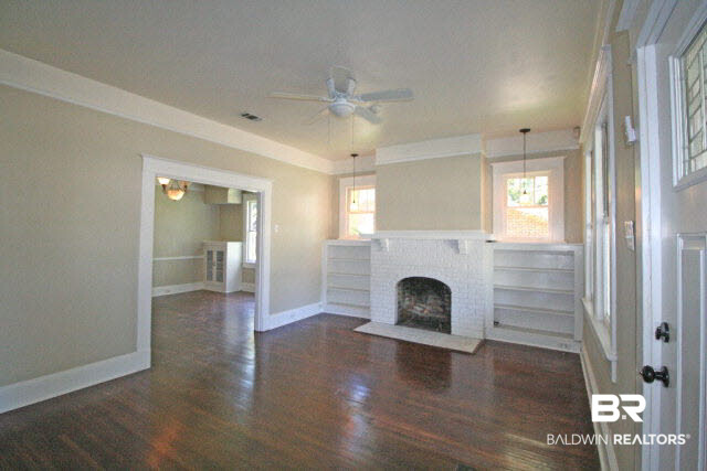 1557 Church Street Mobile, AL 36604 - Photo 2 of 24 Family room with brick fireplace and hardwood floors