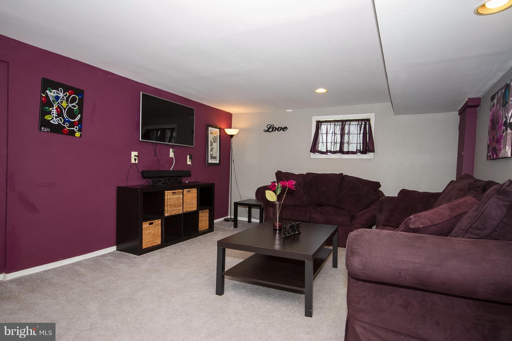 3631 Eitemiller Road Baltimore, MD 21244 - Photo 21 of 27 a living room with furniture and a flat screen tv