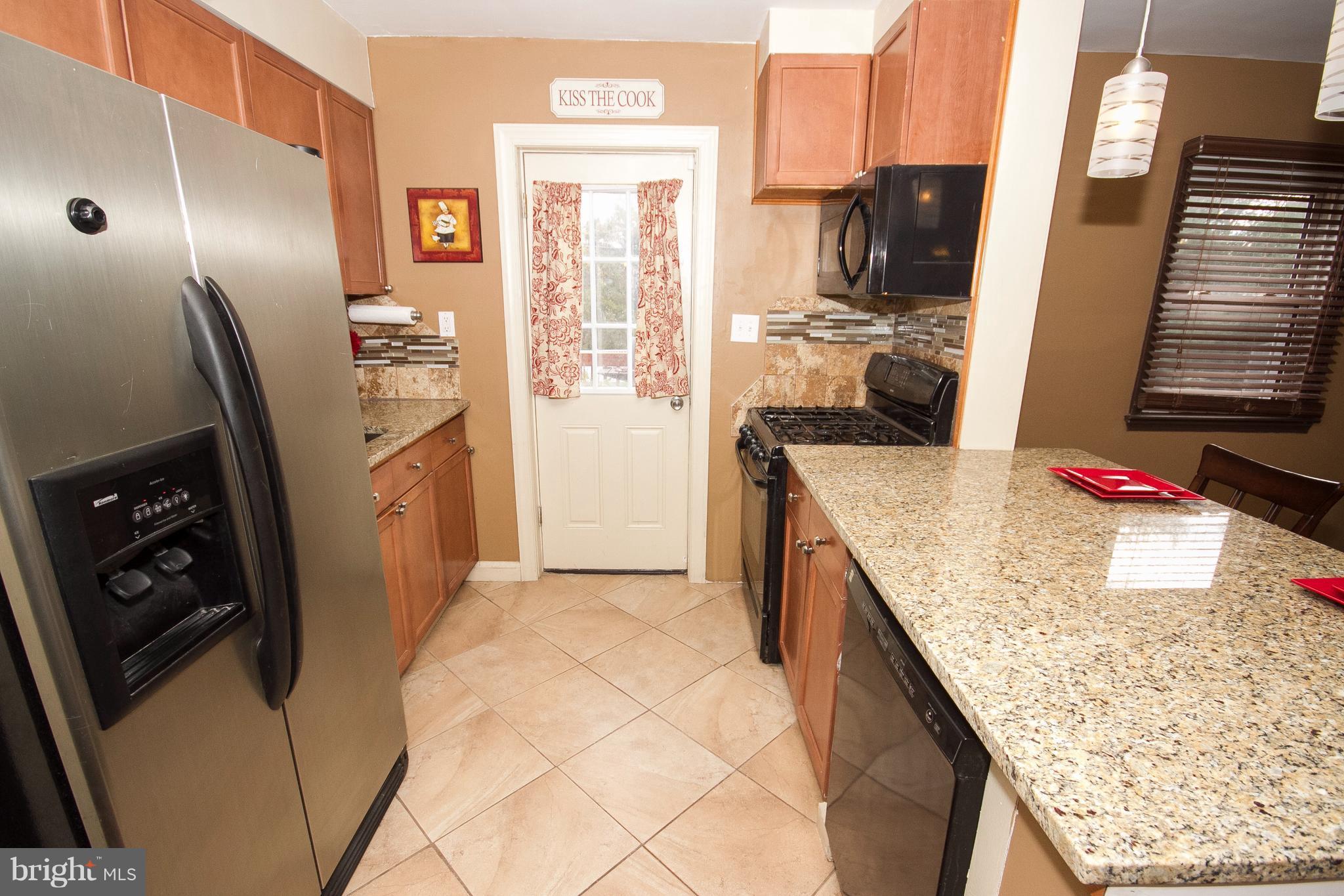 3631 Eitemiller Road Baltimore, MD 21244 - Photo 7 of 27 a kitchen with stainless steel appliances granite countertop a refrigerator a stove and a sink