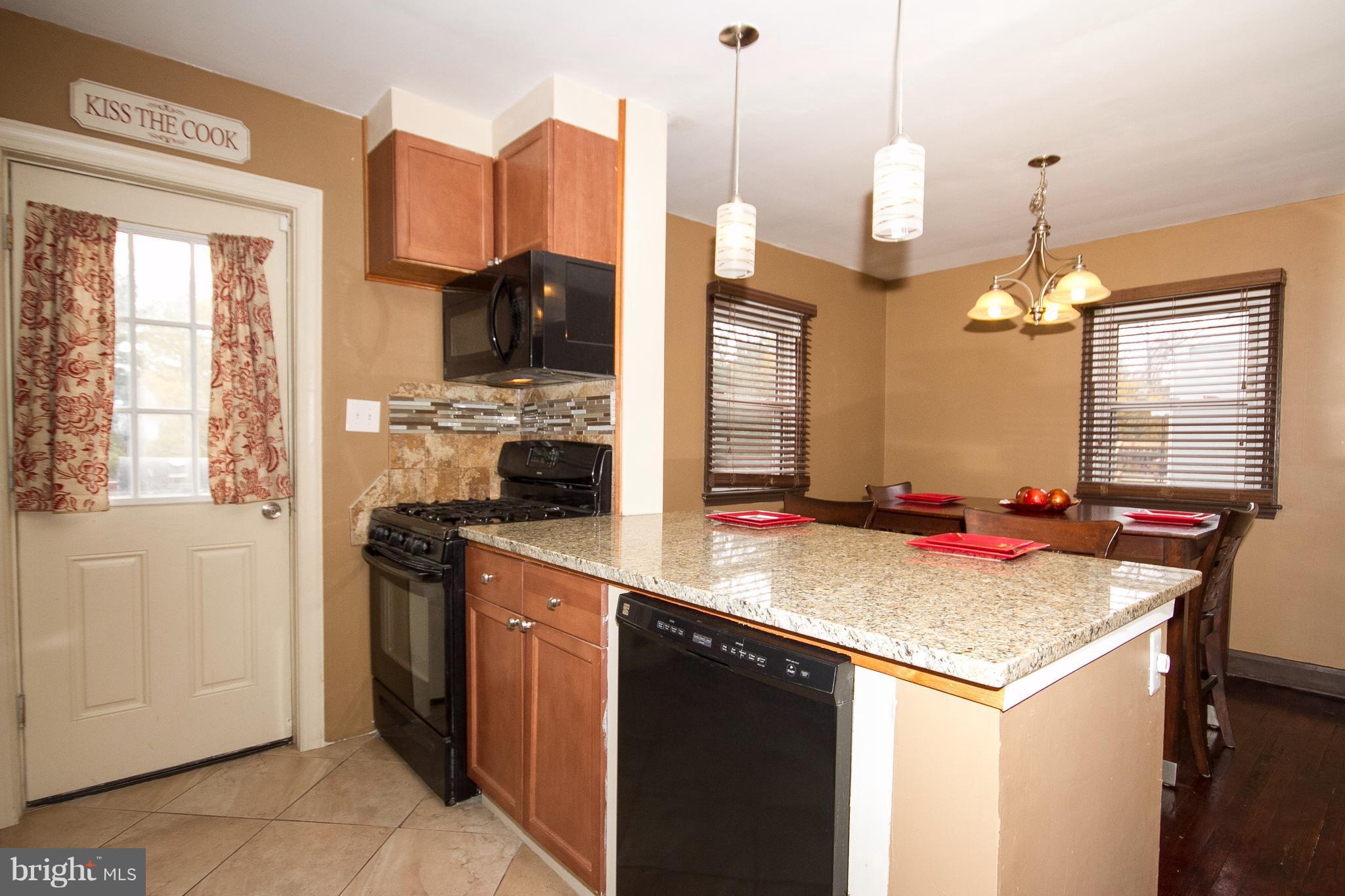 3631 Eitemiller Road Baltimore, MD 21244 - Photo 8 of 27 a kitchen with stainless steel appliances granite countertop a stove and a sink