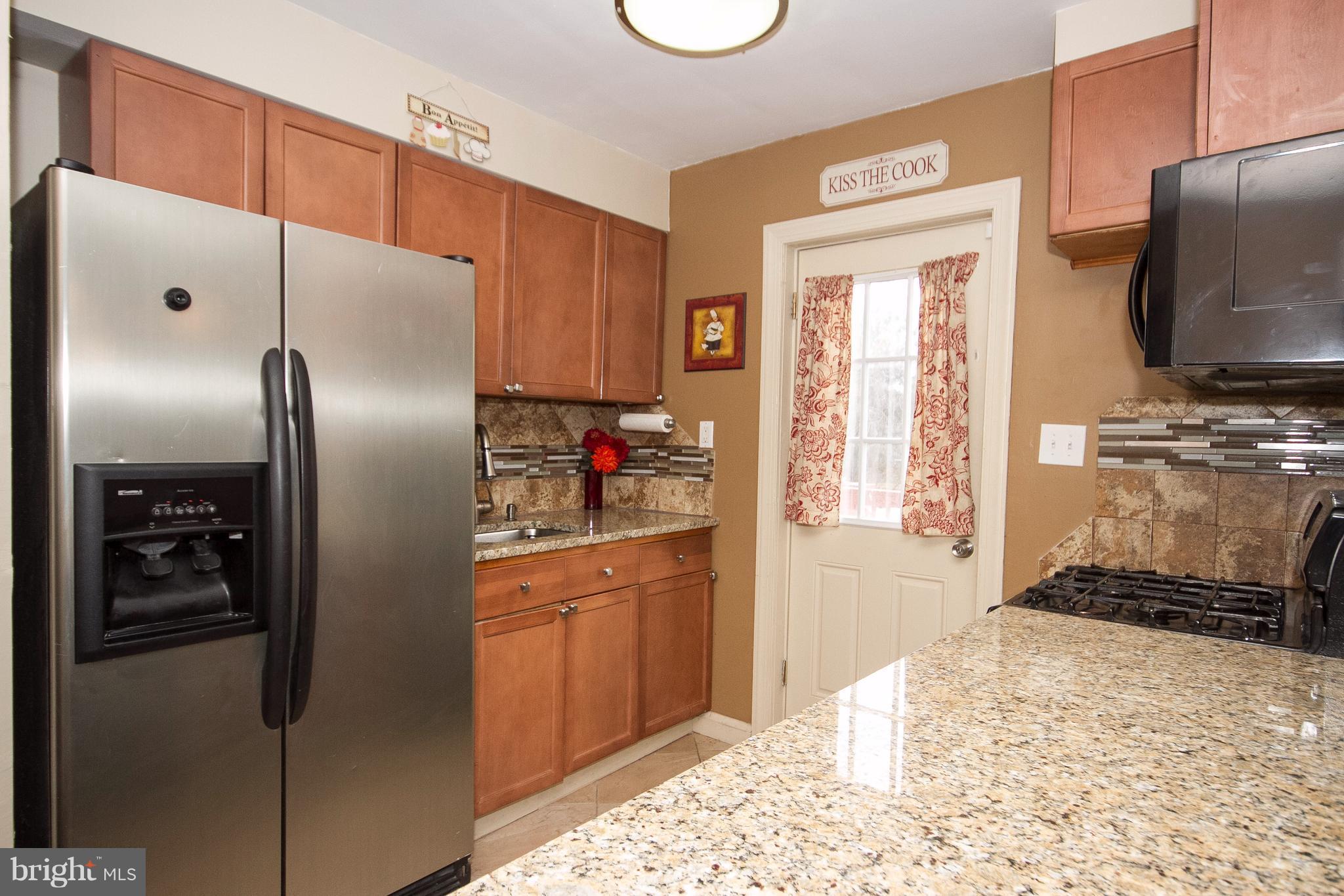 3631 Eitemiller Road Baltimore, MD 21244 - Photo 9 of 27 a kitchen with a refrigerator and a stove top oven