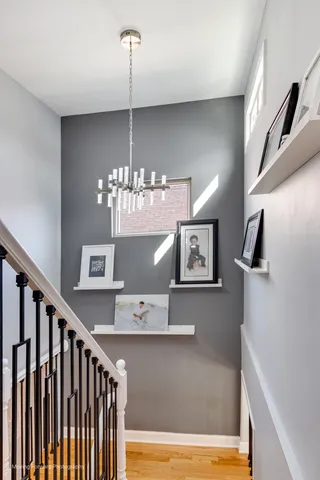 a view of a living room with furniture and a chandelier