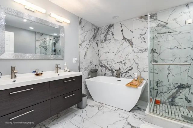 a bathroom with a bathtub sink and mirror