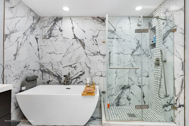 a bathroom with a bathtub and shower