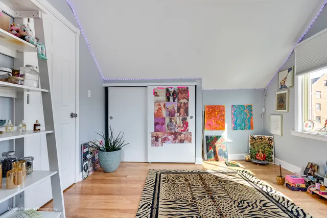 a bedroom with furniture and book shelf